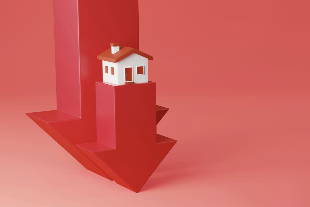 A small white house with a red roof sits atop a large red downward arrow on a red background